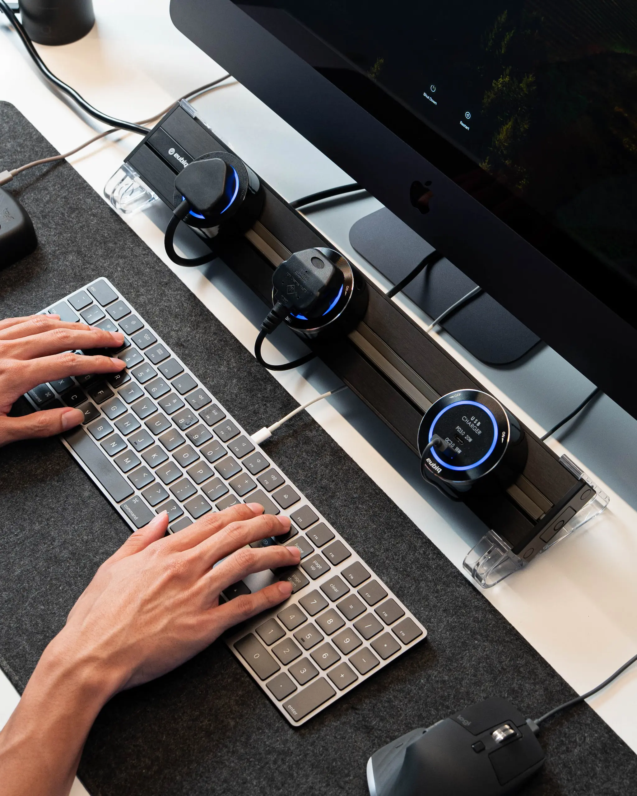 A clean, minimalist desktop setup with an integrated Eubiq track and adapter for convenient, accessible power