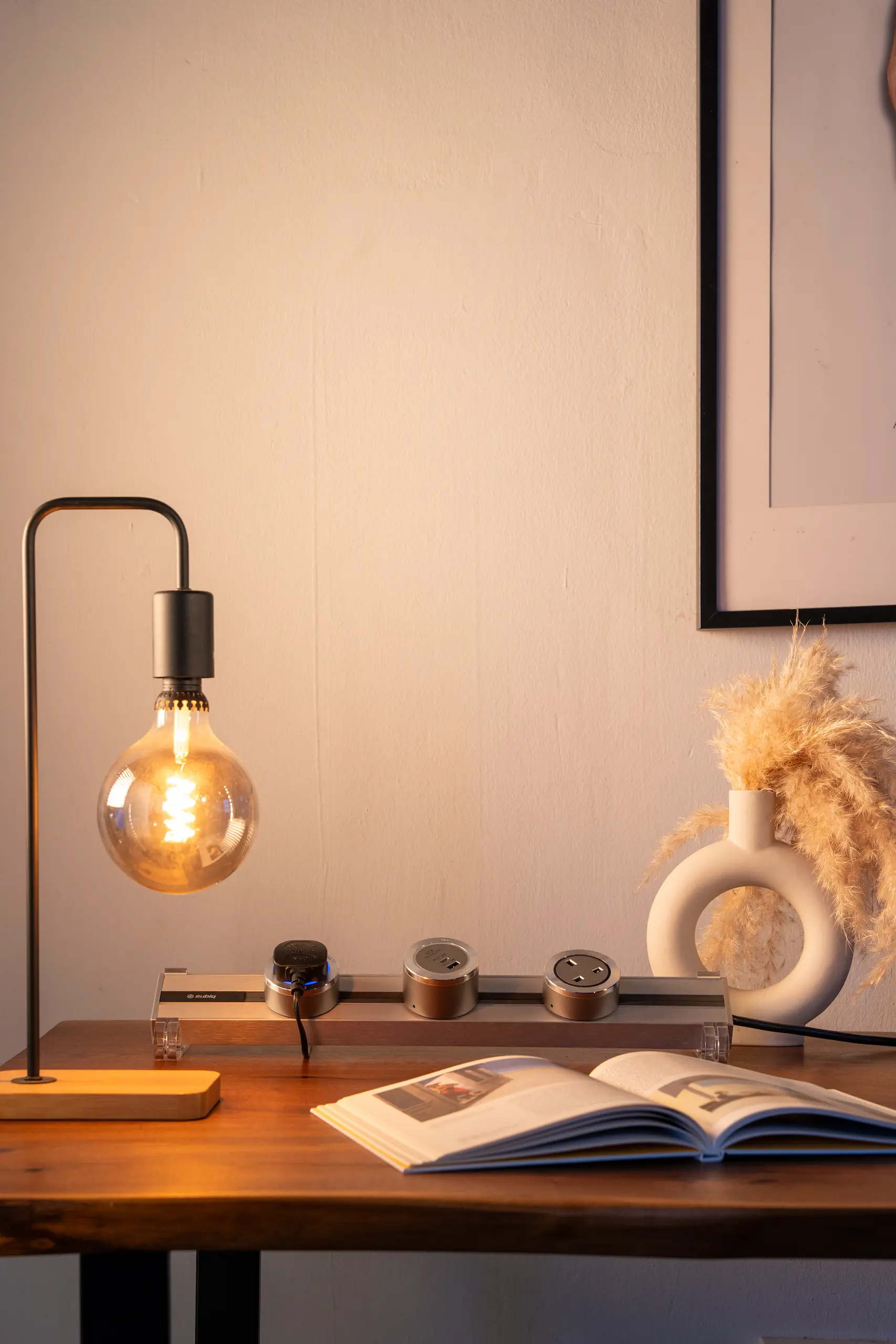 A study table with a lamp powered by an Eubiq track and adapter, creating a focused workspace for productivity.